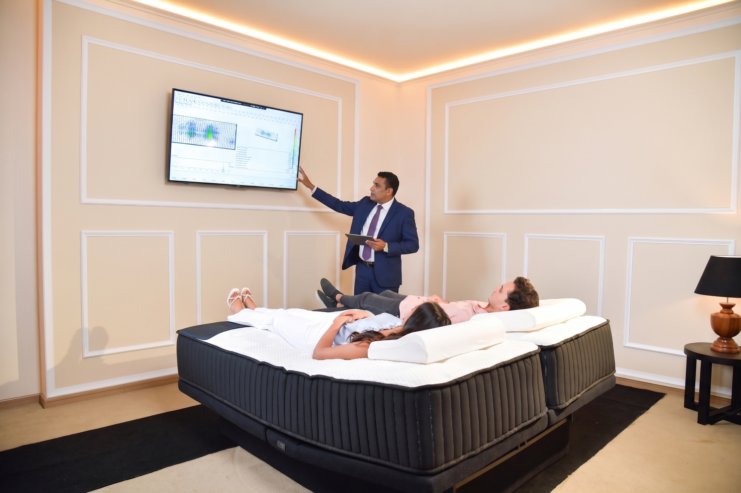 A sleep consultant reviewing pressure-mapping results with customers at the Sleep Technology Centre